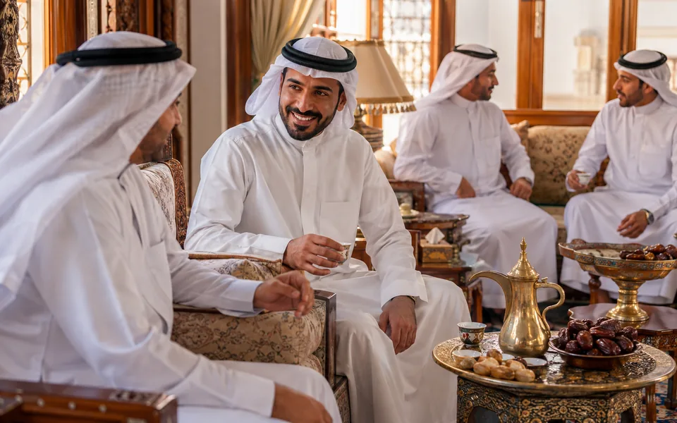 Gulf majlis hospitality with Arabic coffee and dates.